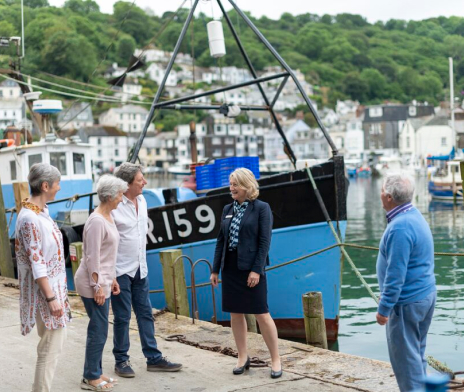 Guests with their Well-being Director by a river