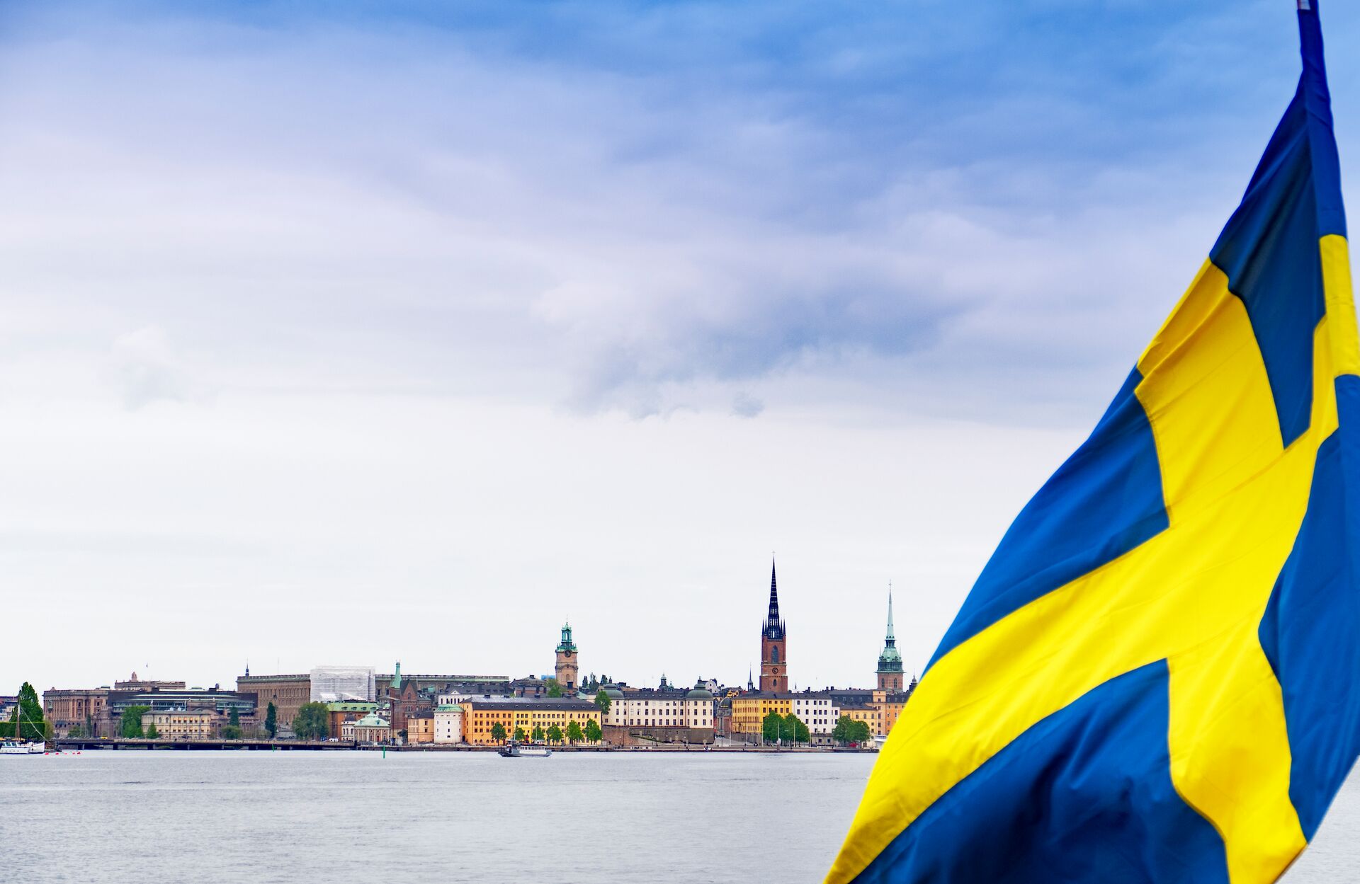 Urban Skyline Of The City Of Stockholm With The Swedish Flag On Foreground