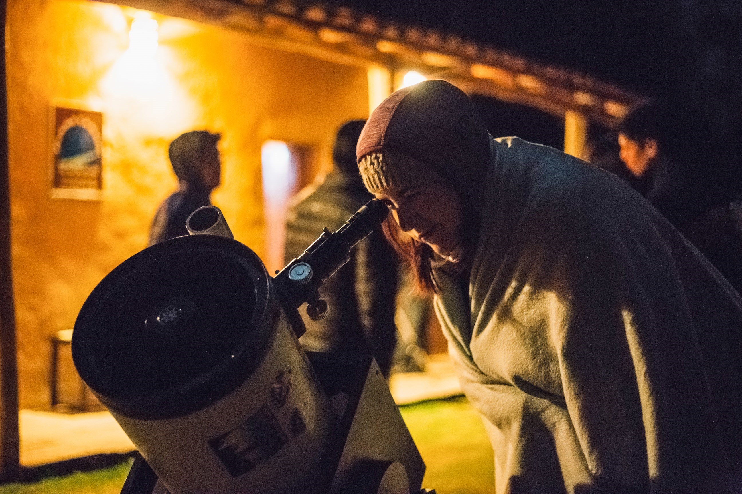 Woman using telescope at the Cusco Planetarium in Peru, South America