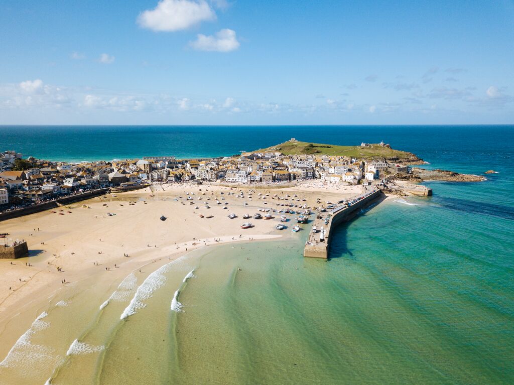 Aerial View Of St Ives, A Wide Sandy Beach And Sheltered Harbour With Boats Beach On Sand At Low Tide