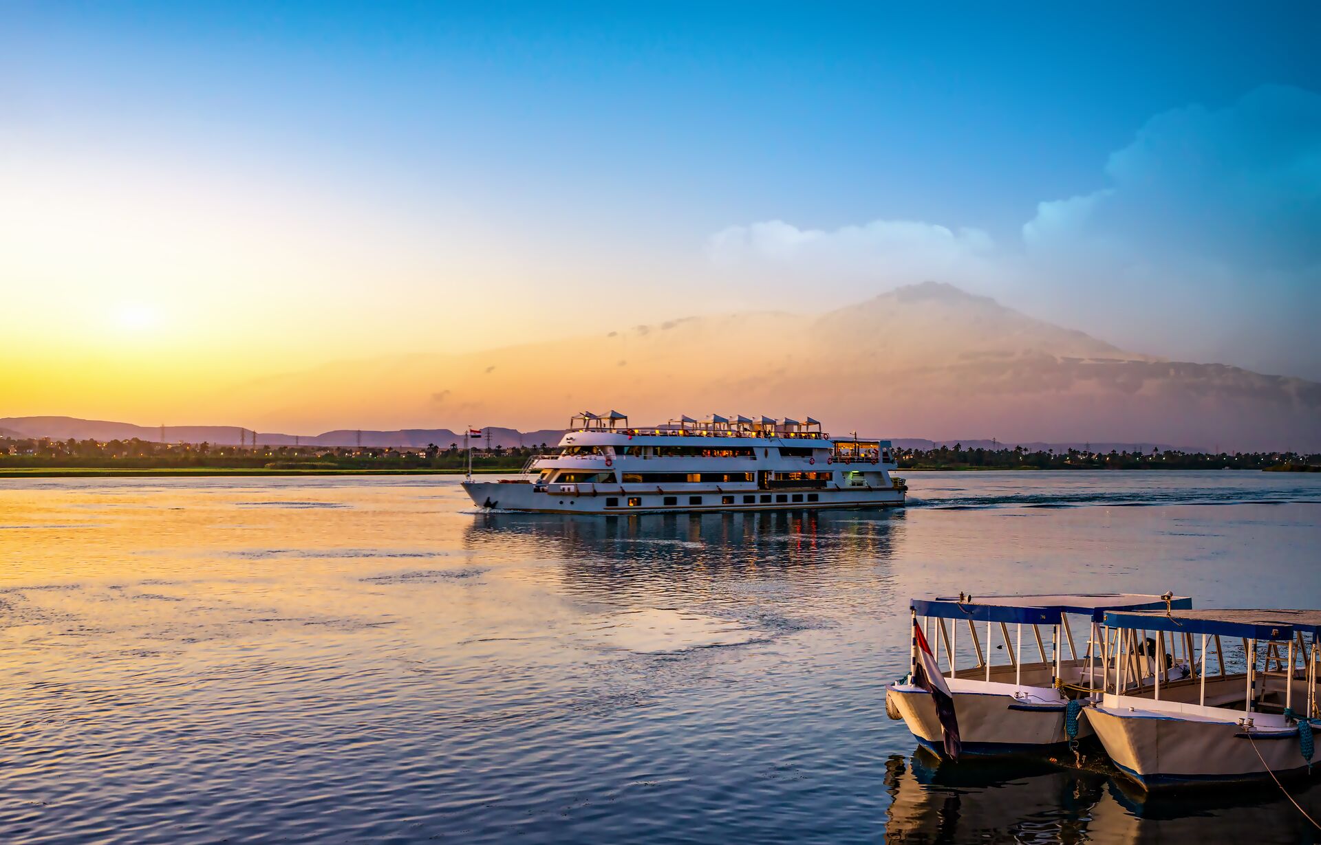 Ship sailing down the River Nile in Egypt during Sunset