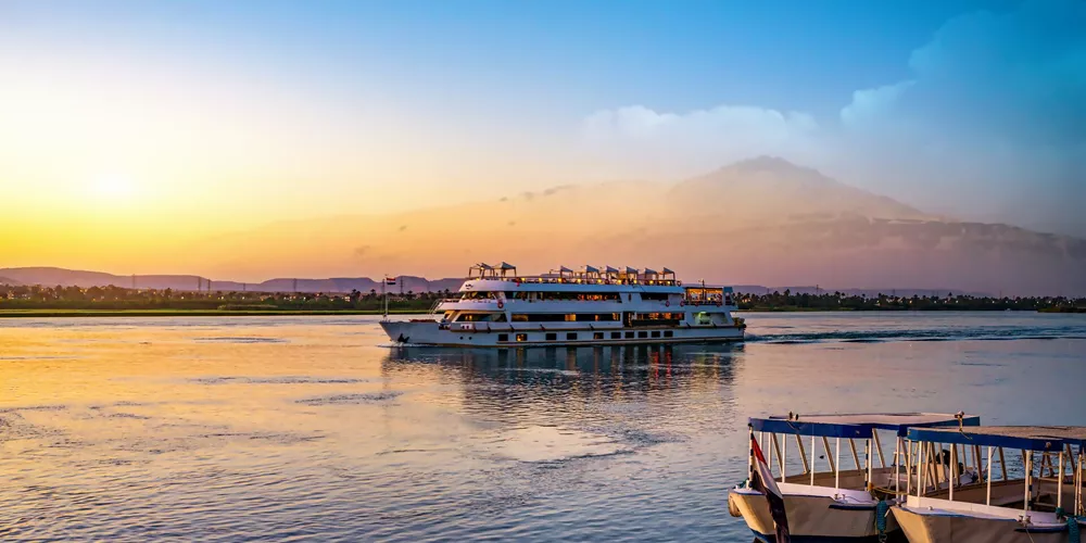 Ship sailing down the River Nile in Egypt during Sunset