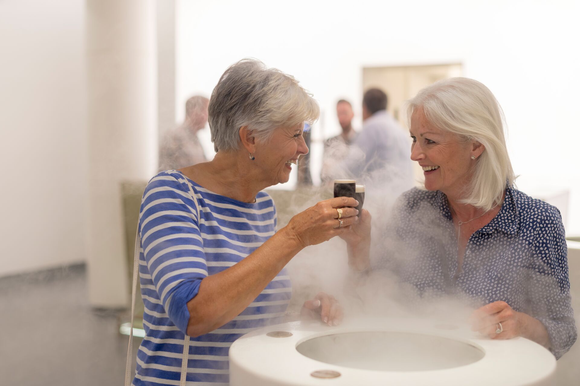 Woman tasting Guinness in the Guinness Factory