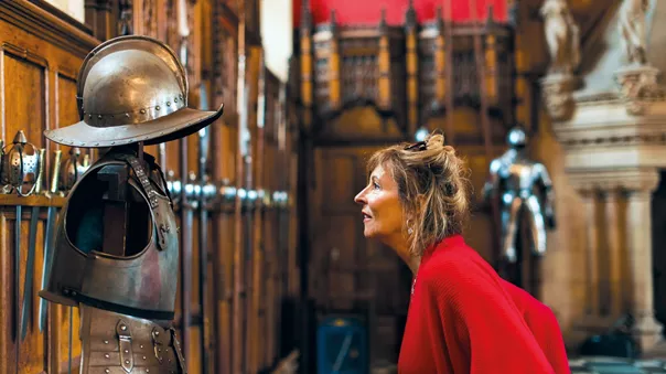 Woman examining some armour in Edinburgh Castle, Edinburgh, Scotland