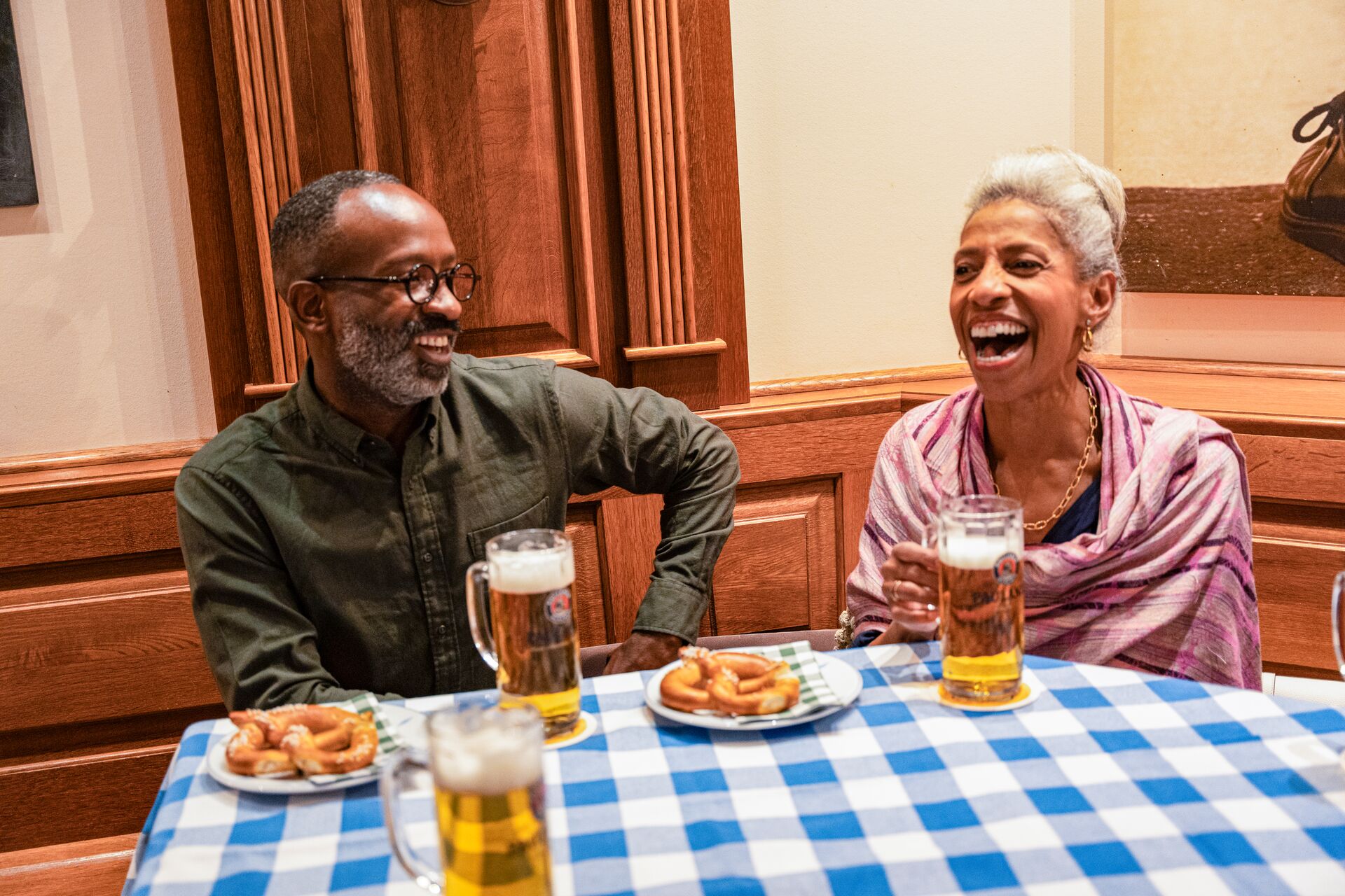 Guests enjoying pretzels and steins at a German Beer Hall