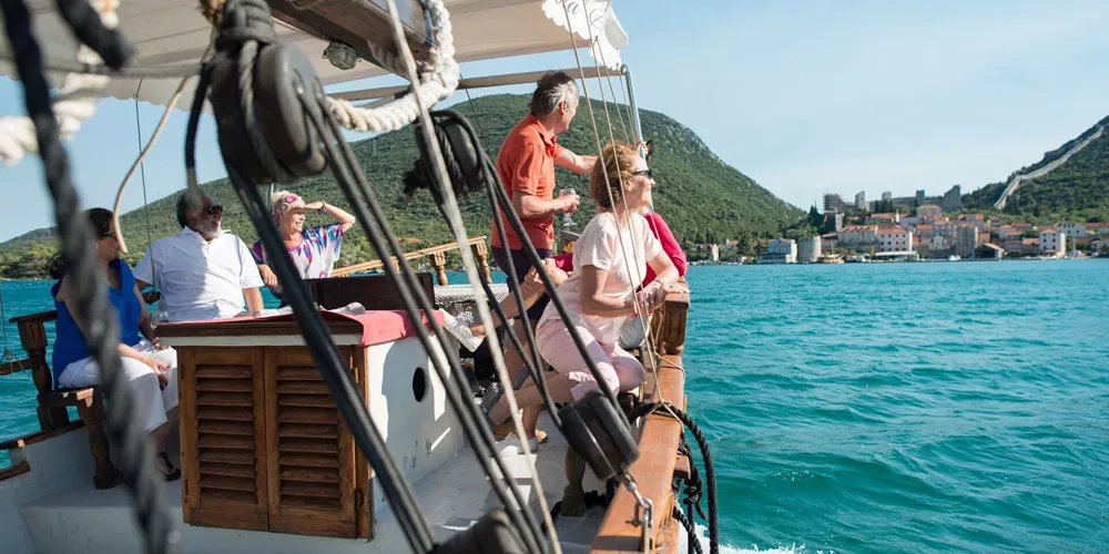 Guests looking out at the view while sailing through the Dalmatian Coast in Croatia
