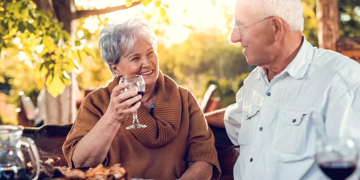 Smiling Senior Couple Drinking Wine And Eating In A Restaurant 492370918