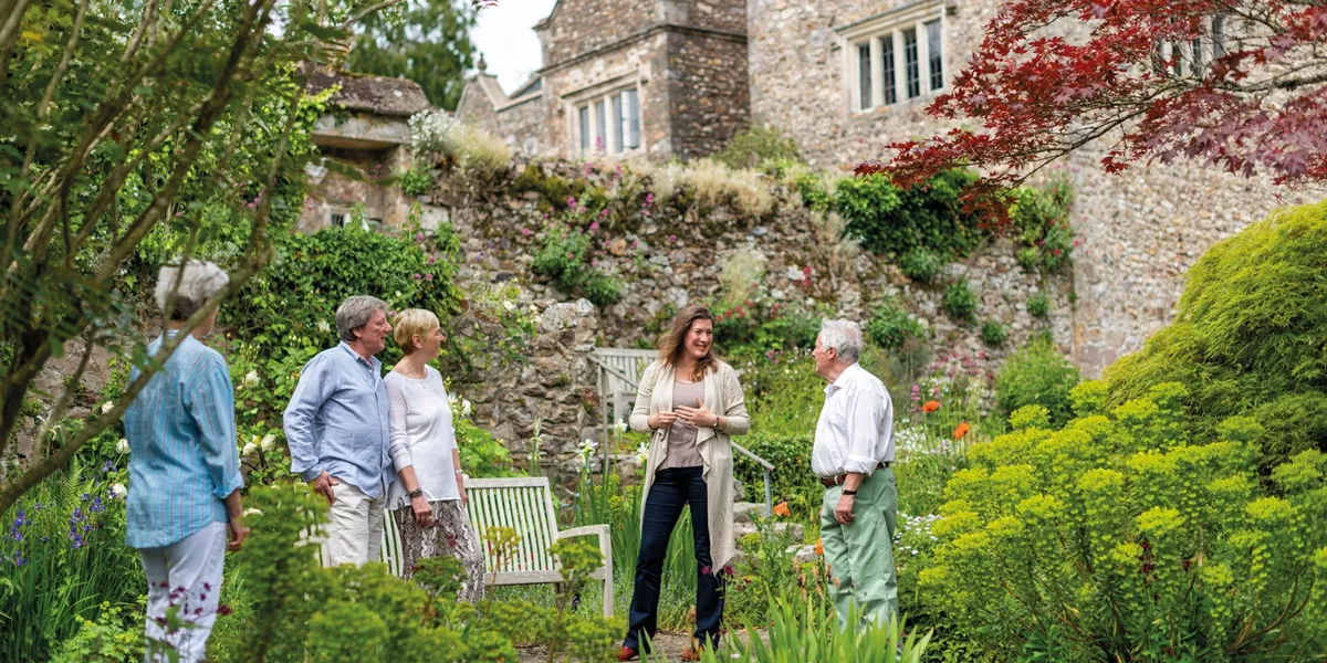 Guest talking to an expert in the garden at Sand House in Devon, England