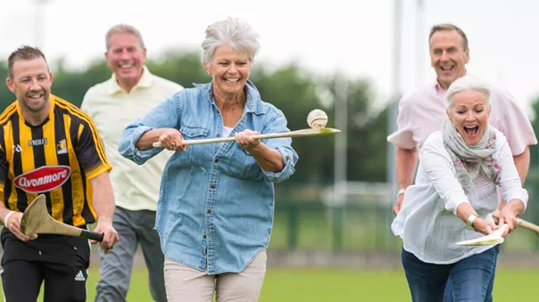 A group of people playing cricket.