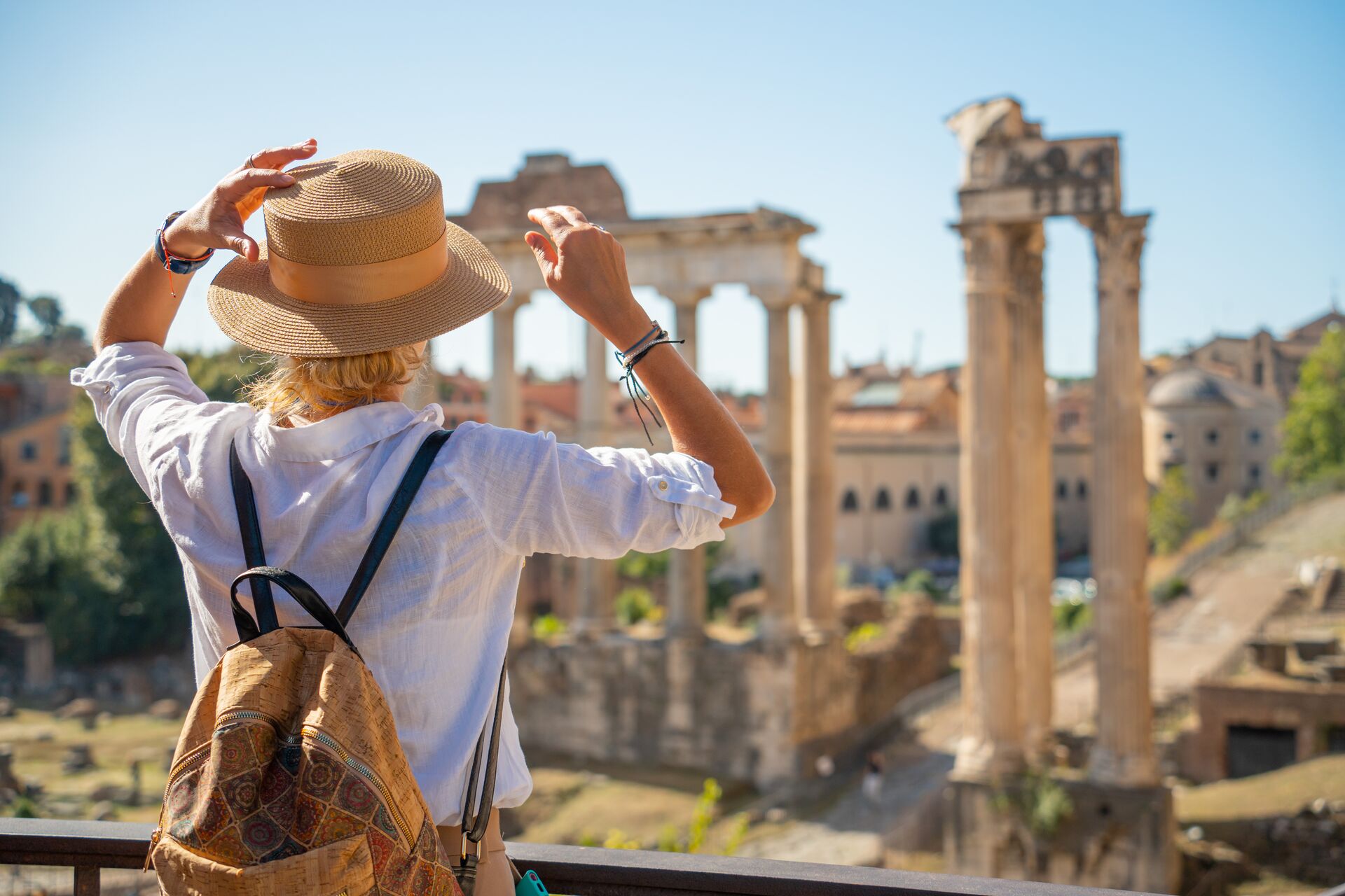 Woman looking at the forum in Rome, Italy on a sunny day