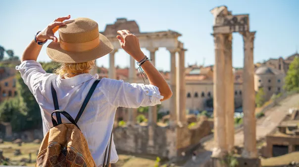 Woman looking at the forum in Rome, Italy on a sunny day