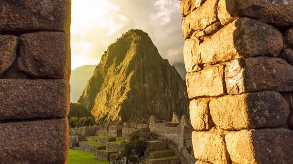 Machu Picchu, Peru peaking through an old stone archway