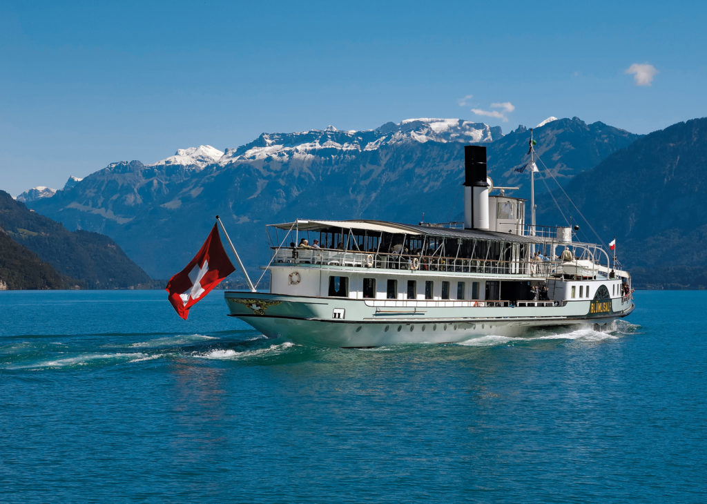 A cruise boat with mountains in the background, Switzerland.