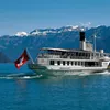 A cruise boat with mountains in the background, Switzerland.