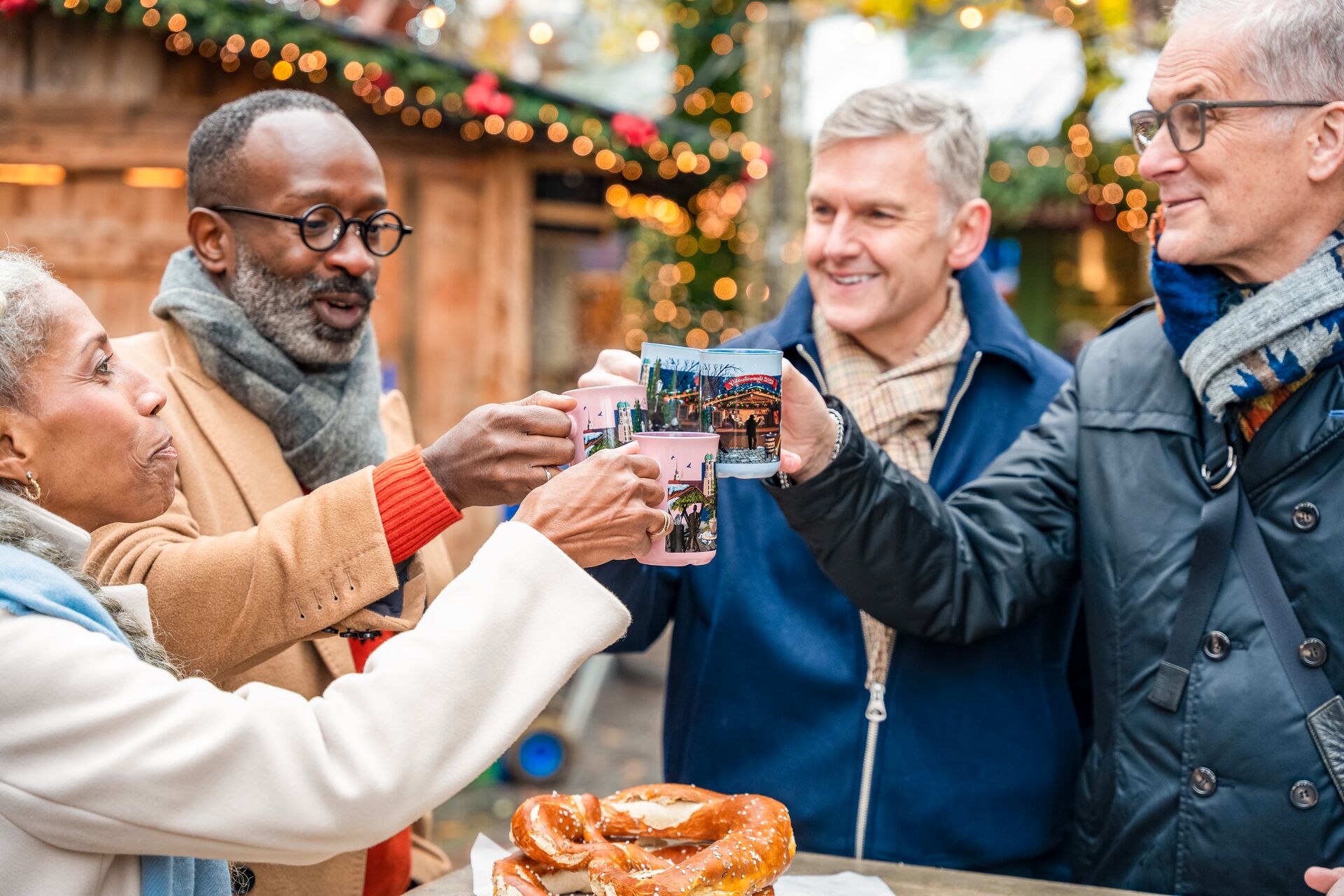 Guests drinking Gluwein at a Christmas Market in Munich, Germany