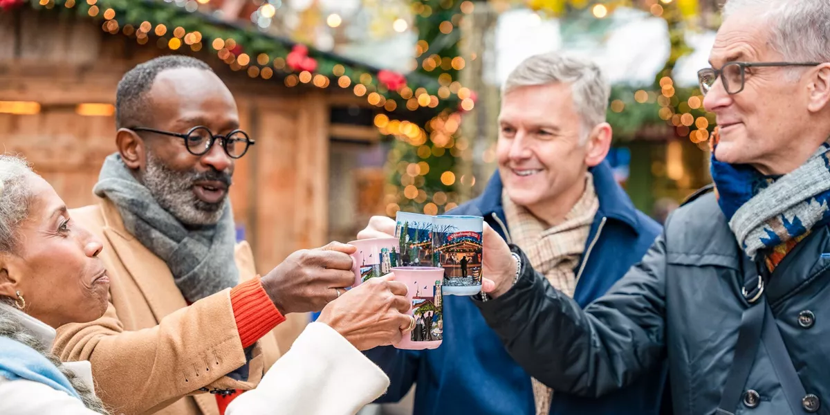 Guests drinking Gluwein at a Christmas Market in Munich, Germany