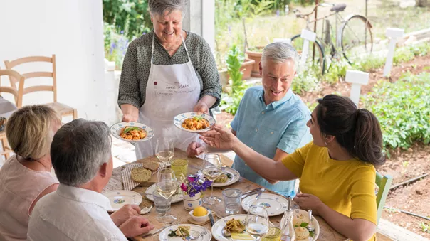 A group of people tasting local dishes