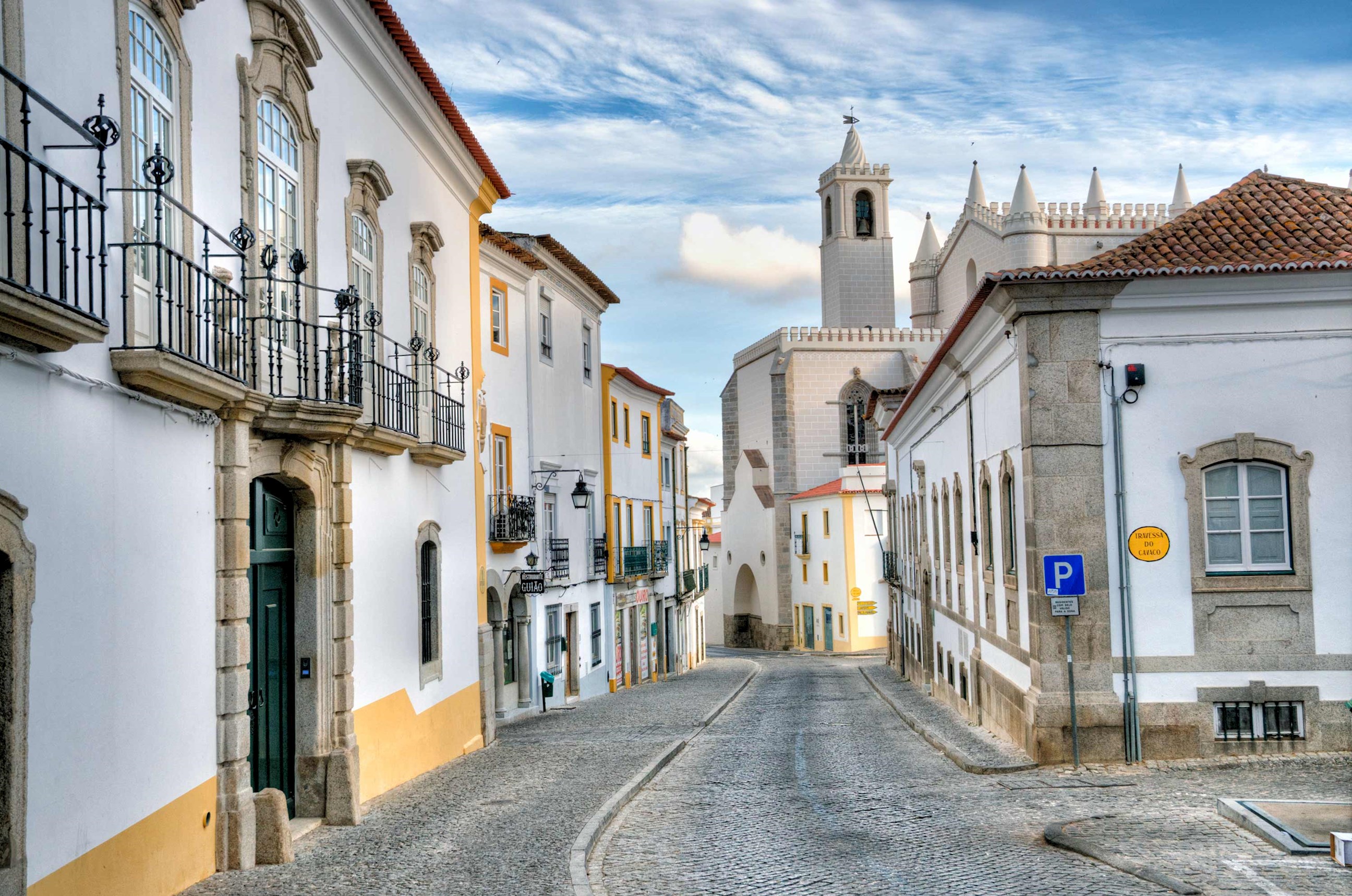 Cobblestone street and Capela dos Ossos in Evora, Portugal