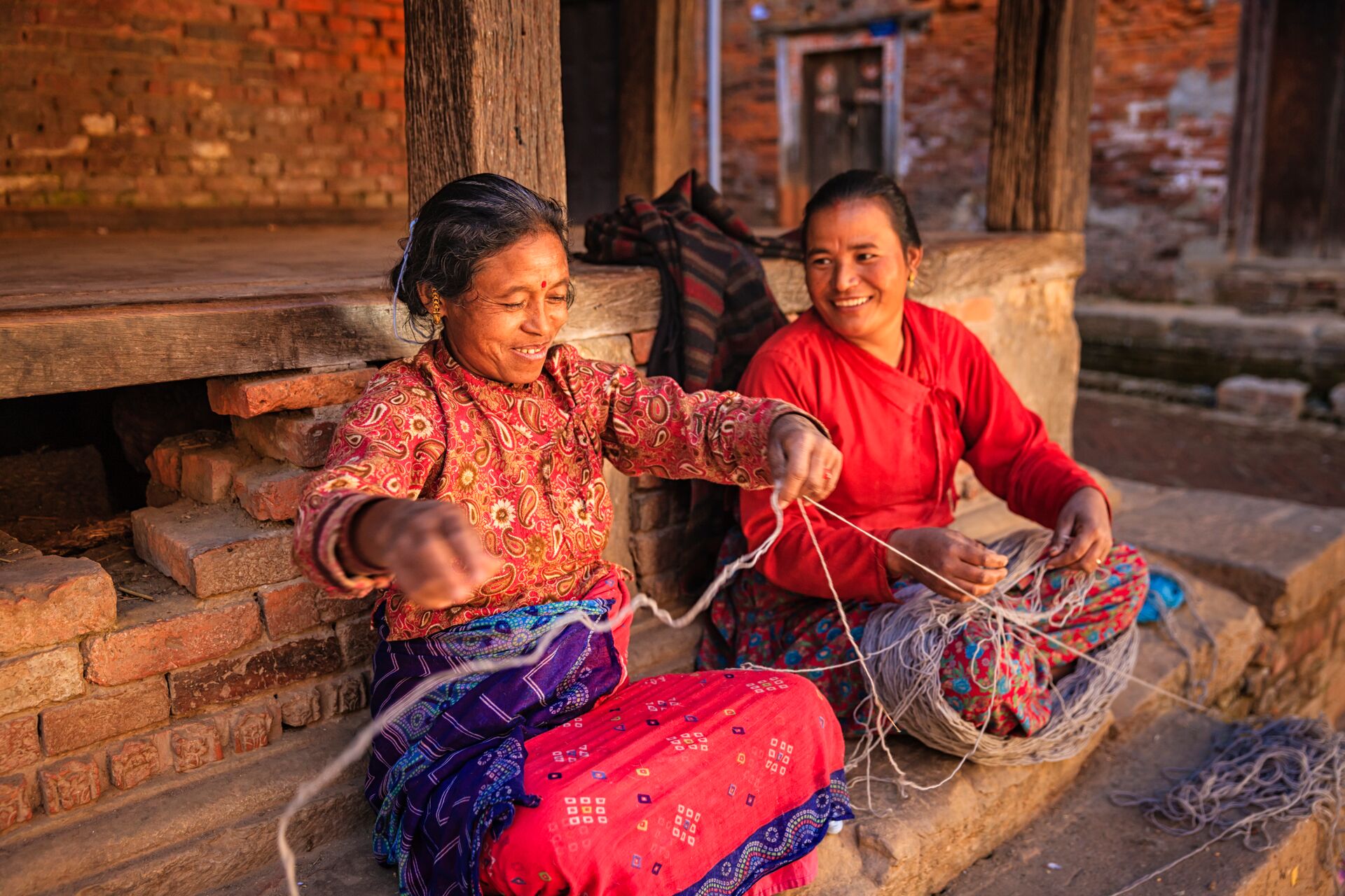 Two Nepali women spinning wool in Bhaktapur, Nepal