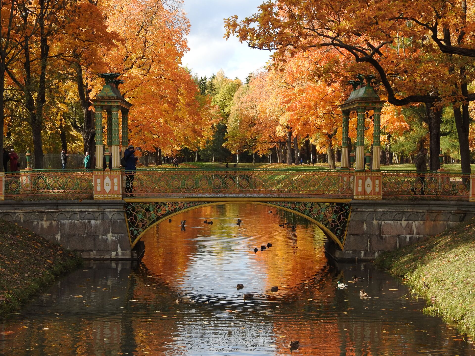 Arch bridge over a lake during autumn