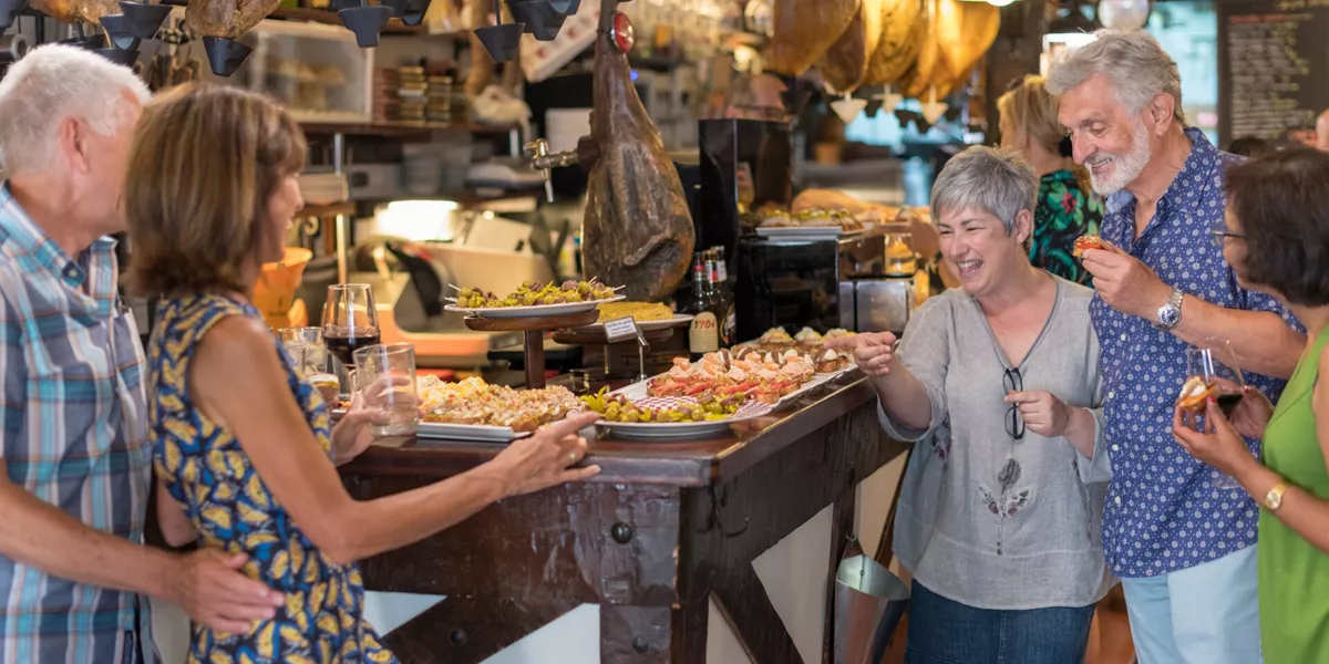Group of tourists enjoying tapas in a bar in San Sebastian, Spain