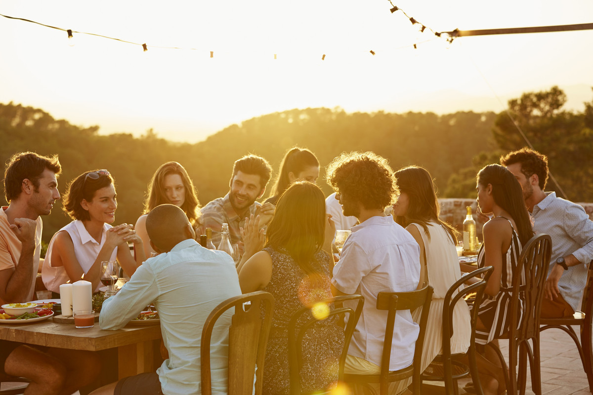 Group of friends dining at sunset