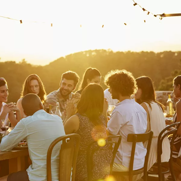 Group of friends dining at sunset