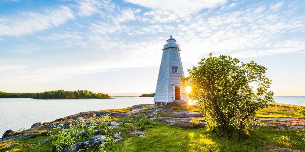 Sun setting on a traditional light house in Sweden, Scandinavia