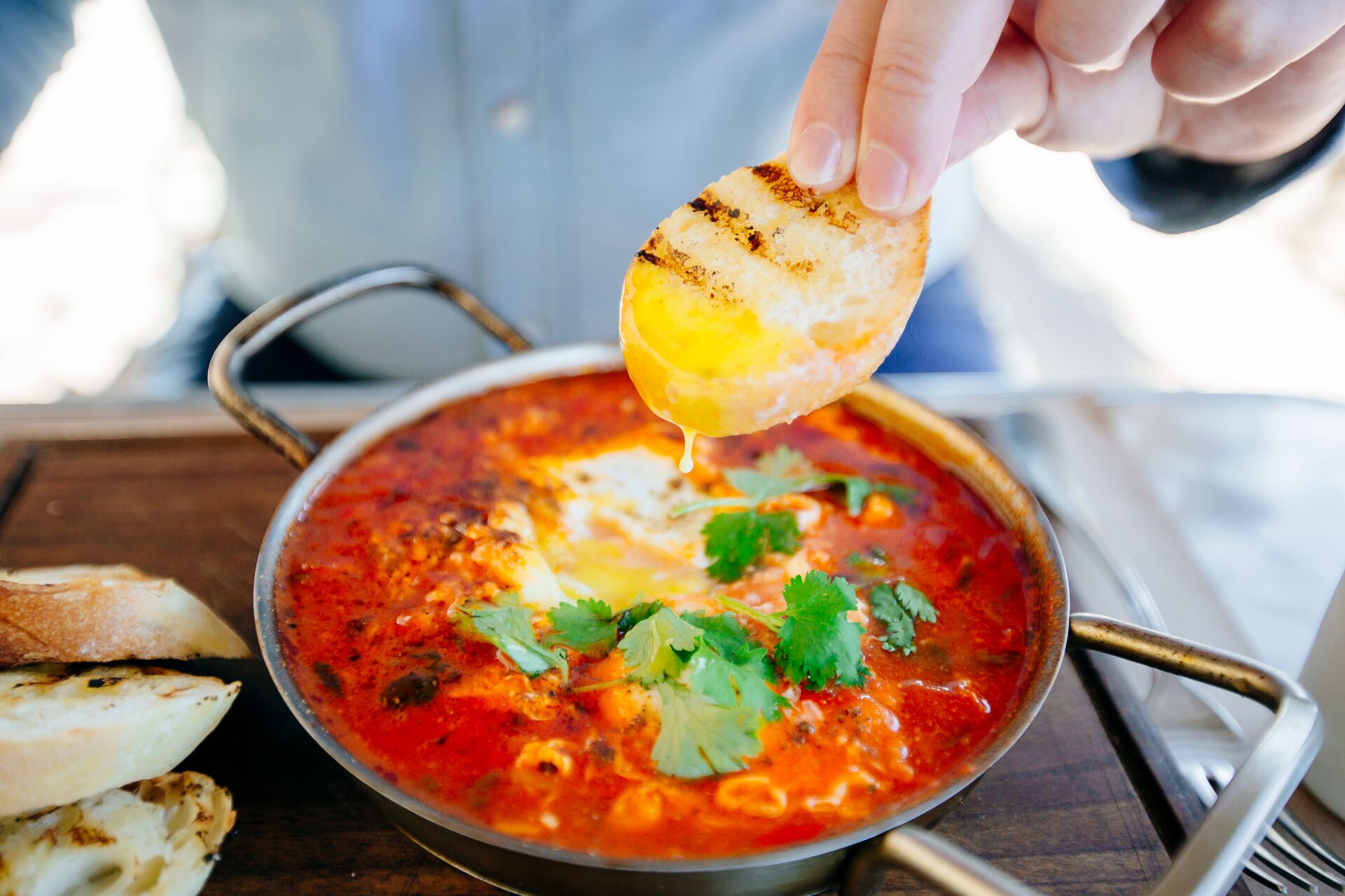 Large Dipping Fresh Bread In Shakshuka, Close Up 1147769013