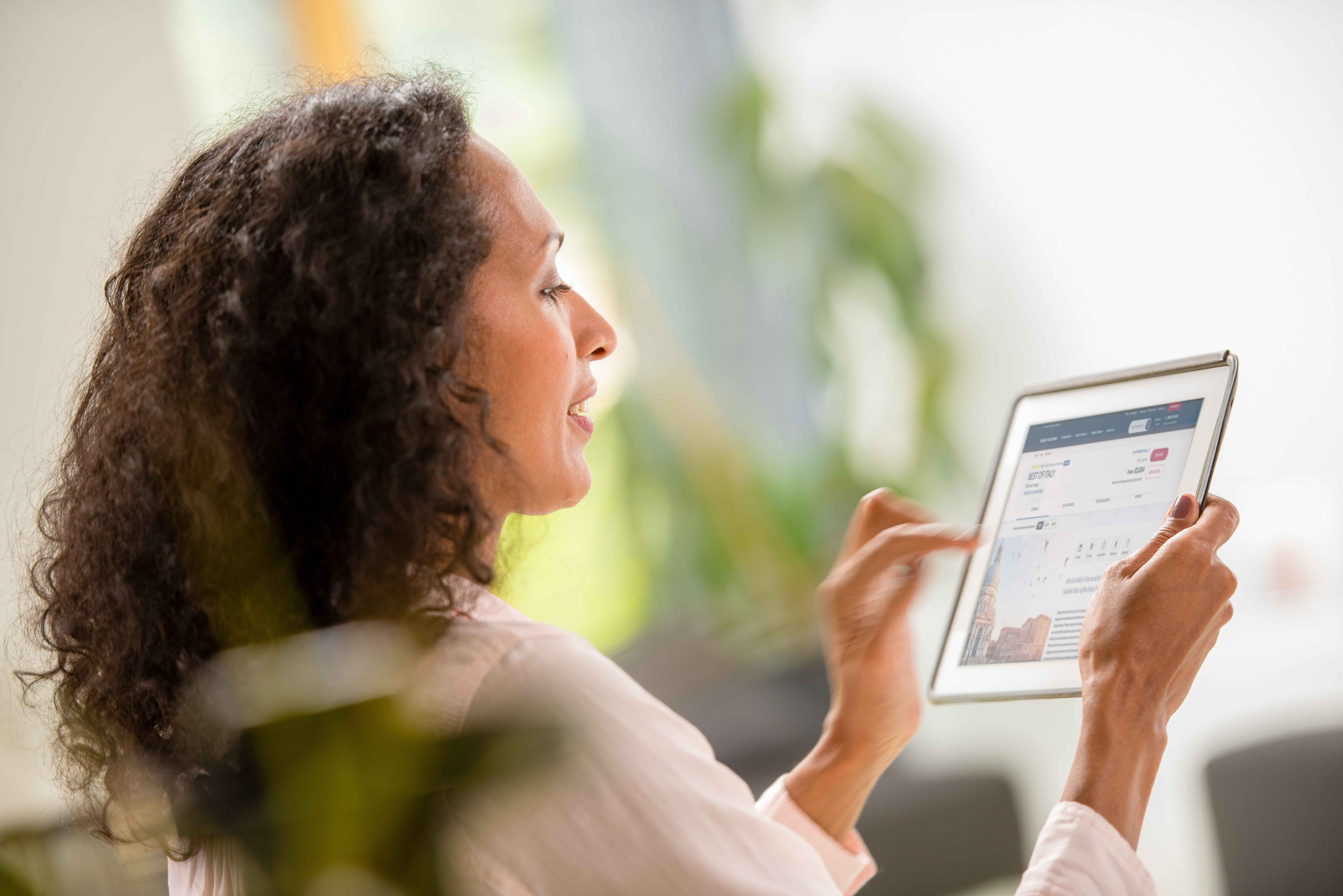Woman sat, relaxing while requesting a quote on the Insight Vacations website