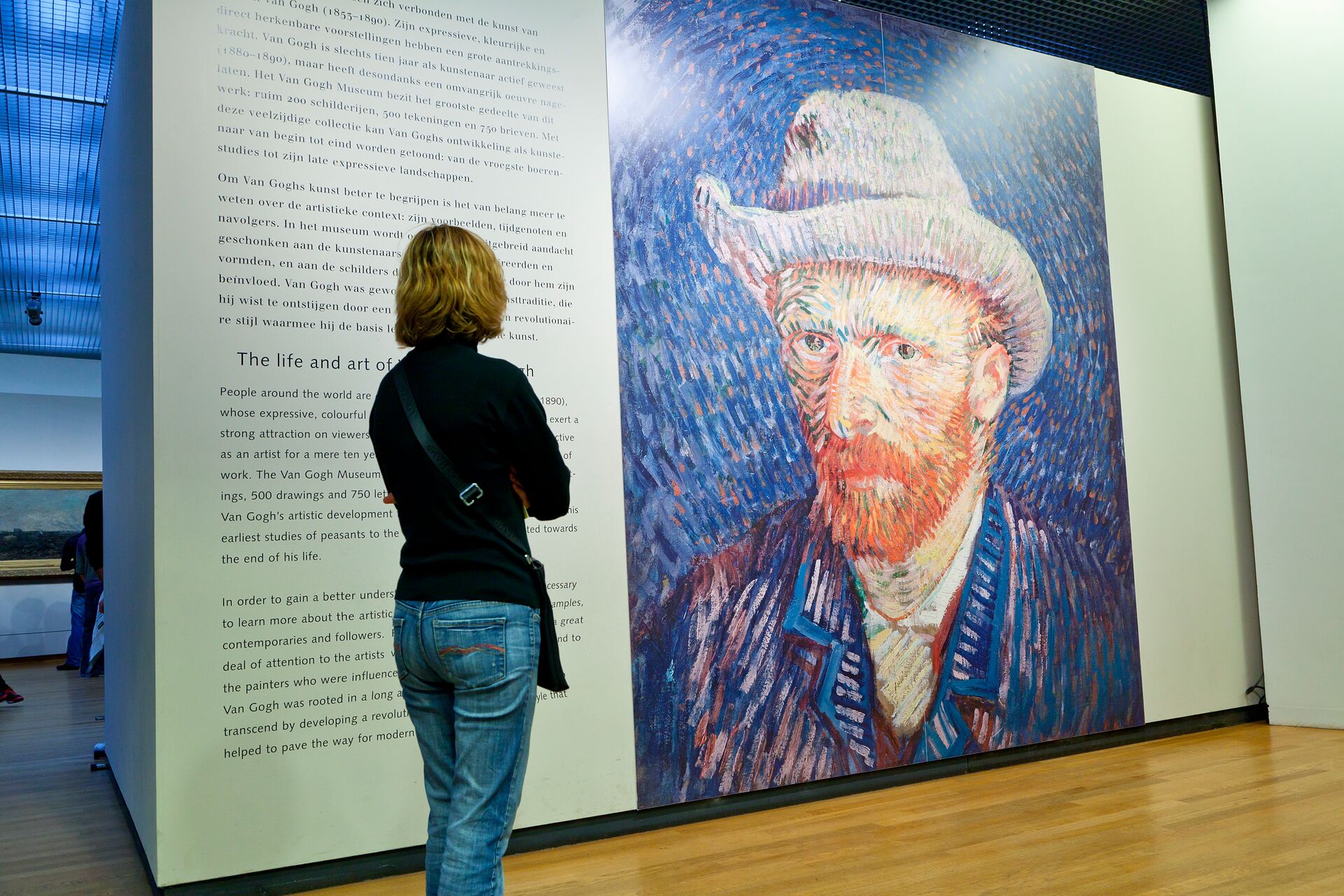 Woman looking at the famous self portrait in The Van Gogh Museum in Amsterdam, The Netherlands