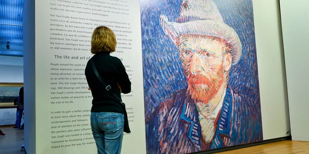 Woman looking at the famous self portrait in The Van Gogh Museum in Amsterdam, The Netherlands