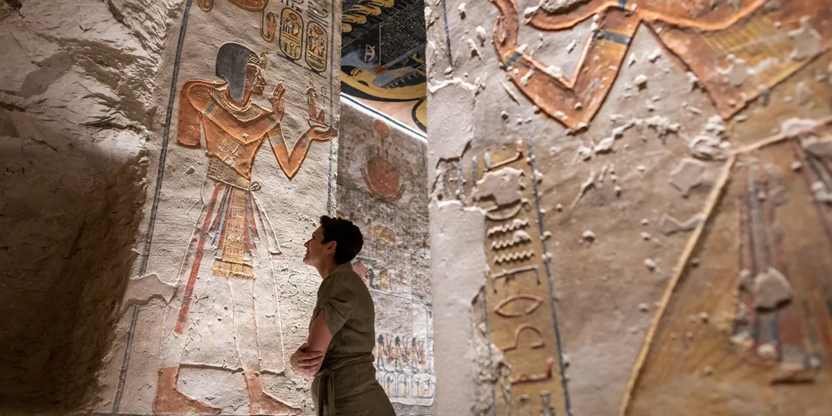 Woman looking up at the Hieroglyphics in Ramesses VI Tomb in Luxor, Egypt