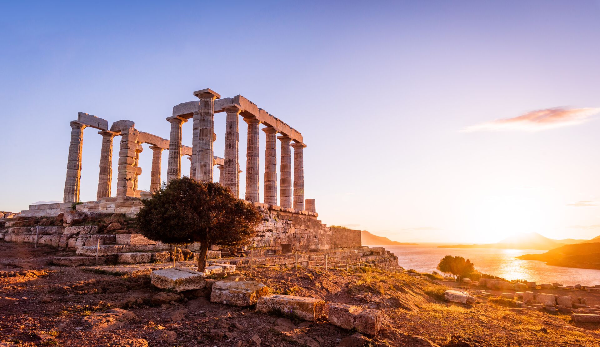 Temple Of Zeus At Sounion with the sun setting in the background