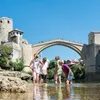 Guests enjoy a dip near the old bridge Mostar, Bosnia and Herzegovina