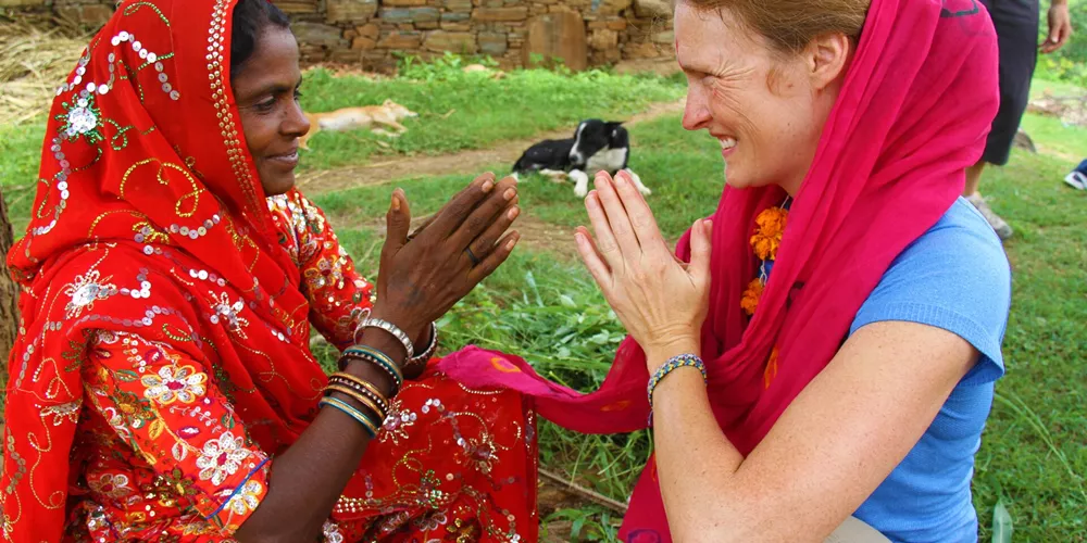 A tourist interacting with an Indian woman