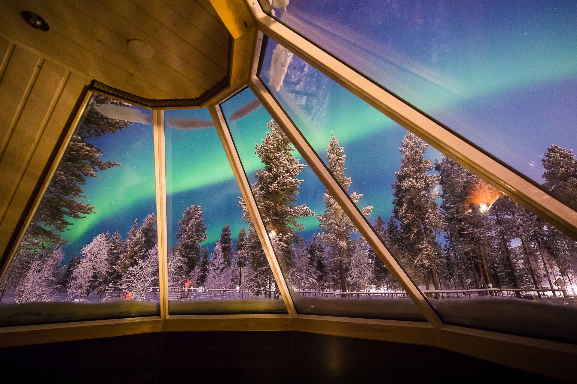 Northern Lights as seen through a cabin window in the Aurora Village in Ivalo, Finland