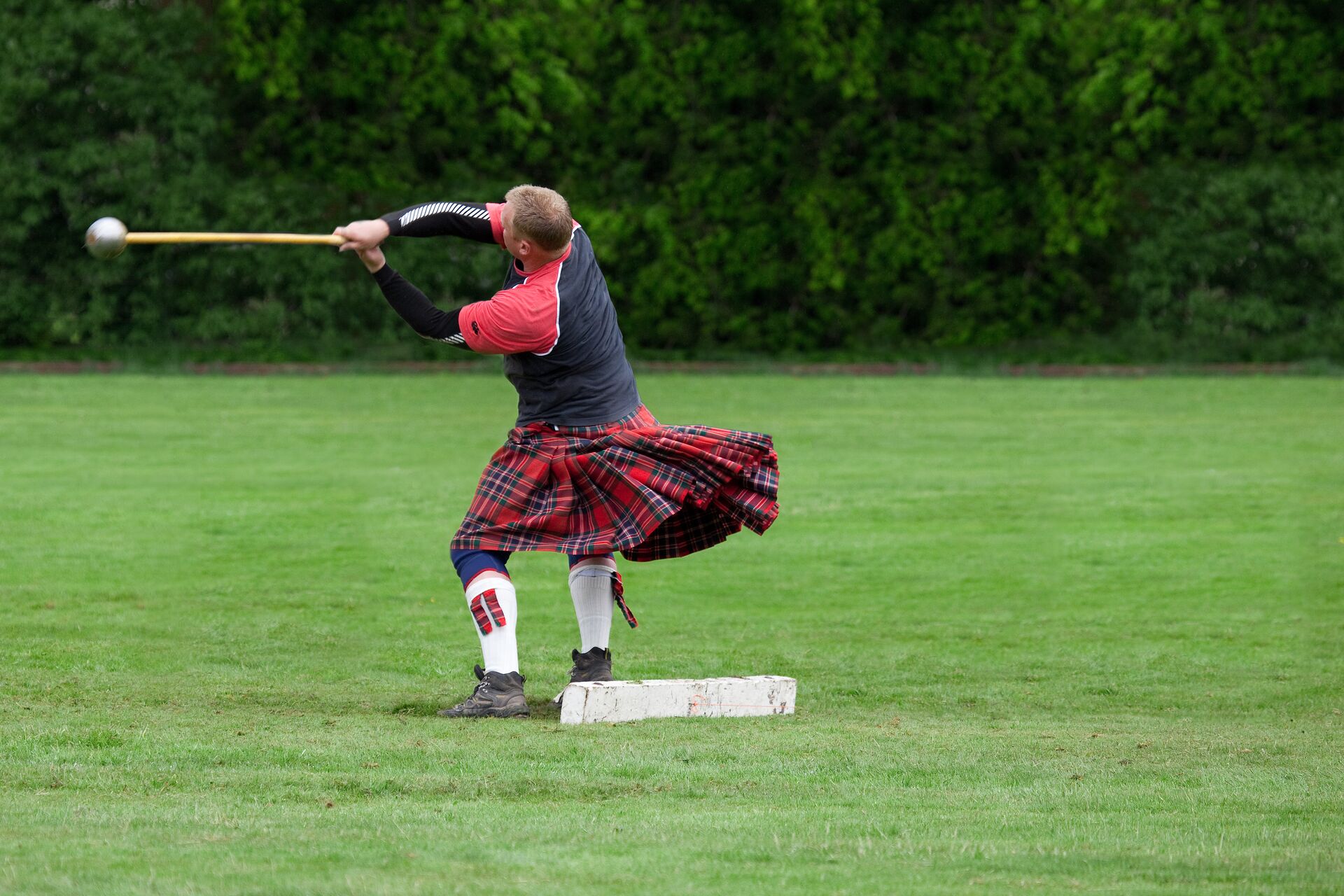 A man competing in the Highland games