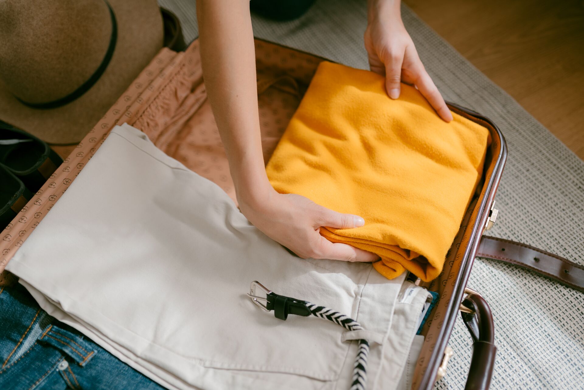 Aerial view of a woman packing her suitcase