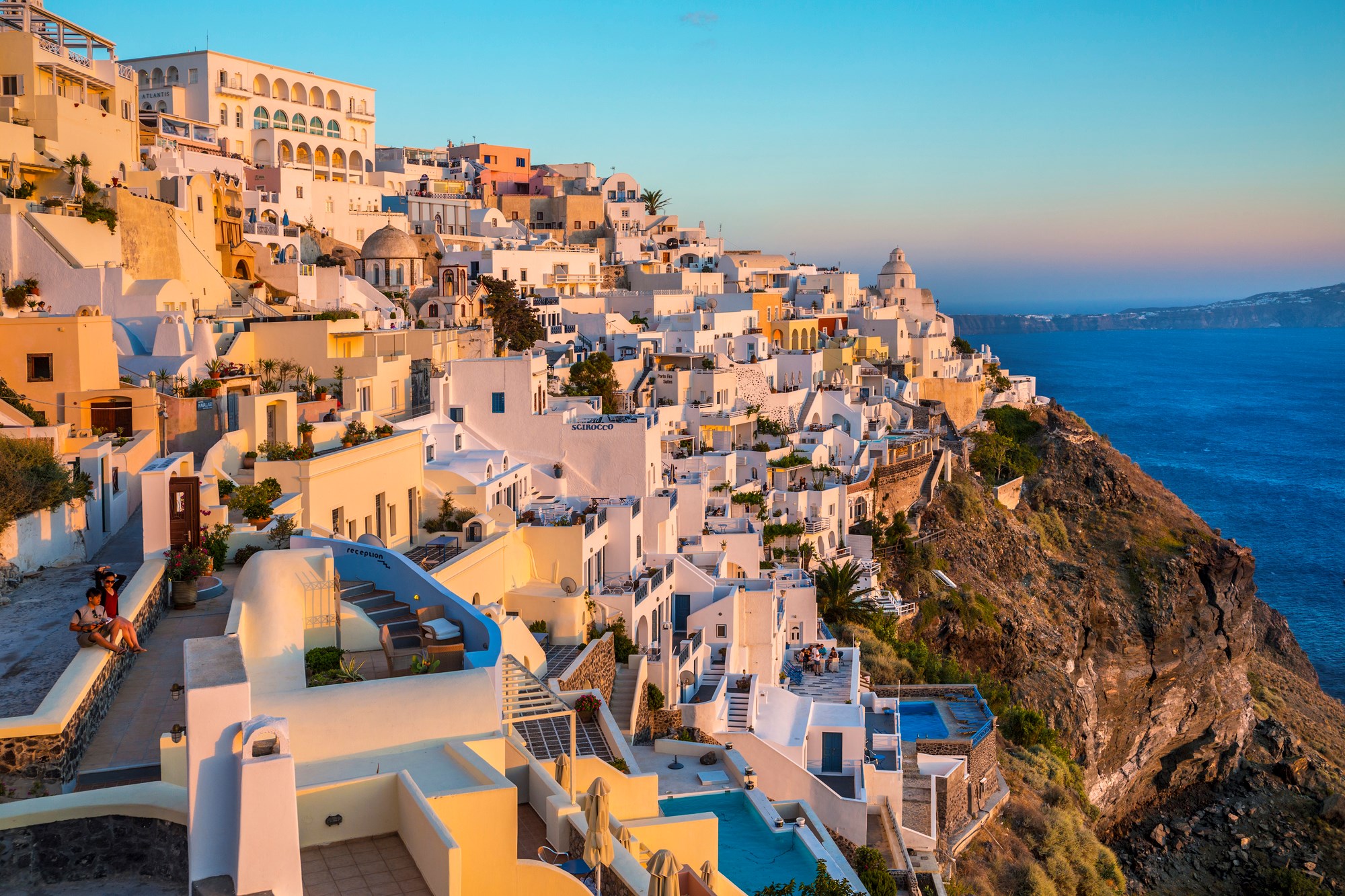 Scenic town view at sunset in Thira, Greece.