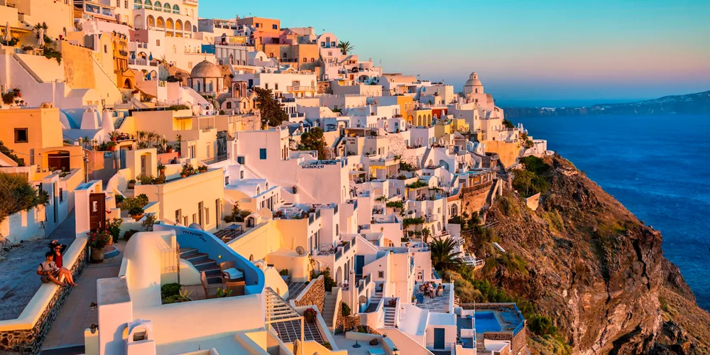 Scenic town view at sunset in Thira, Greece.
