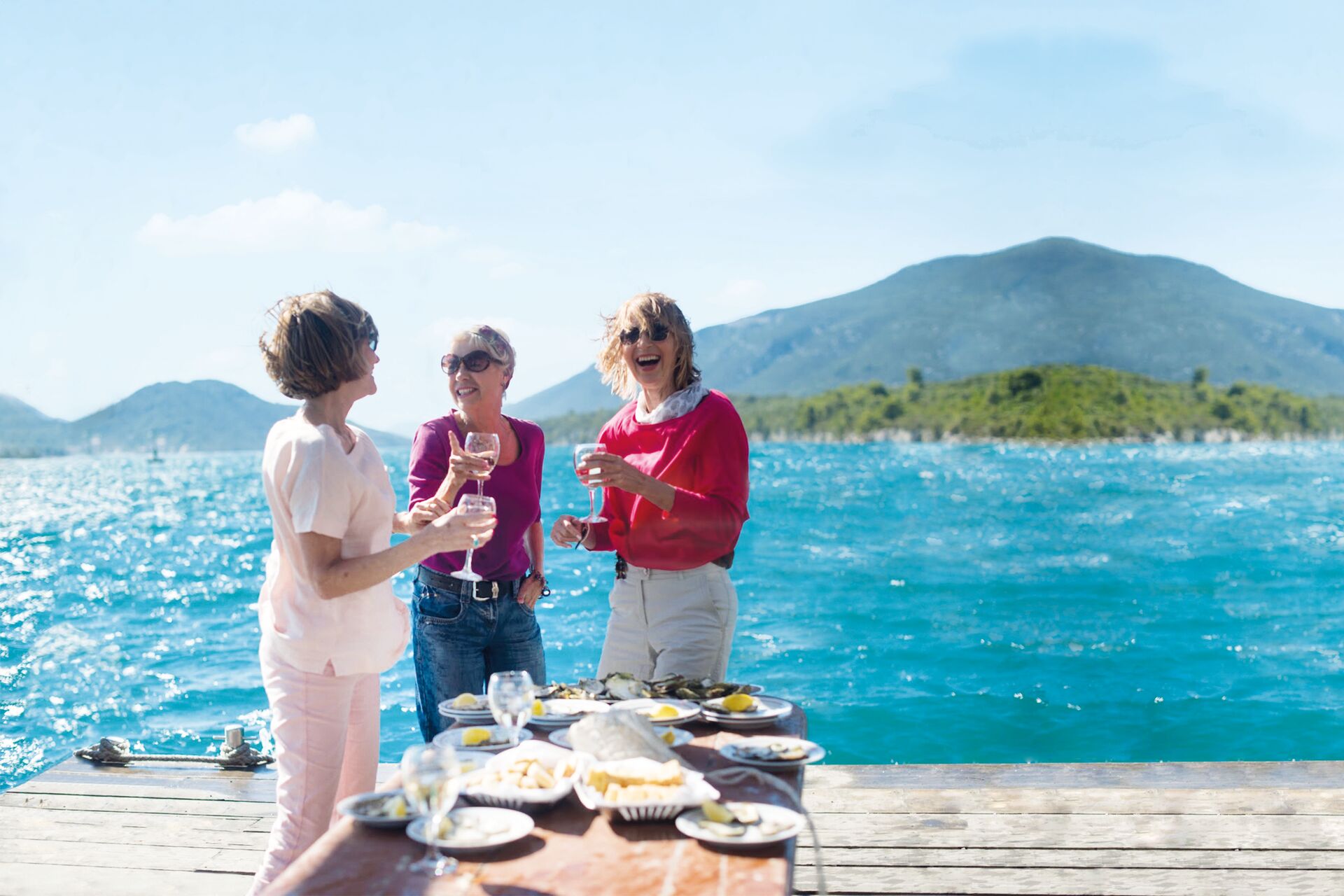 Women enjoying oyster tasting by the sea in Croatia