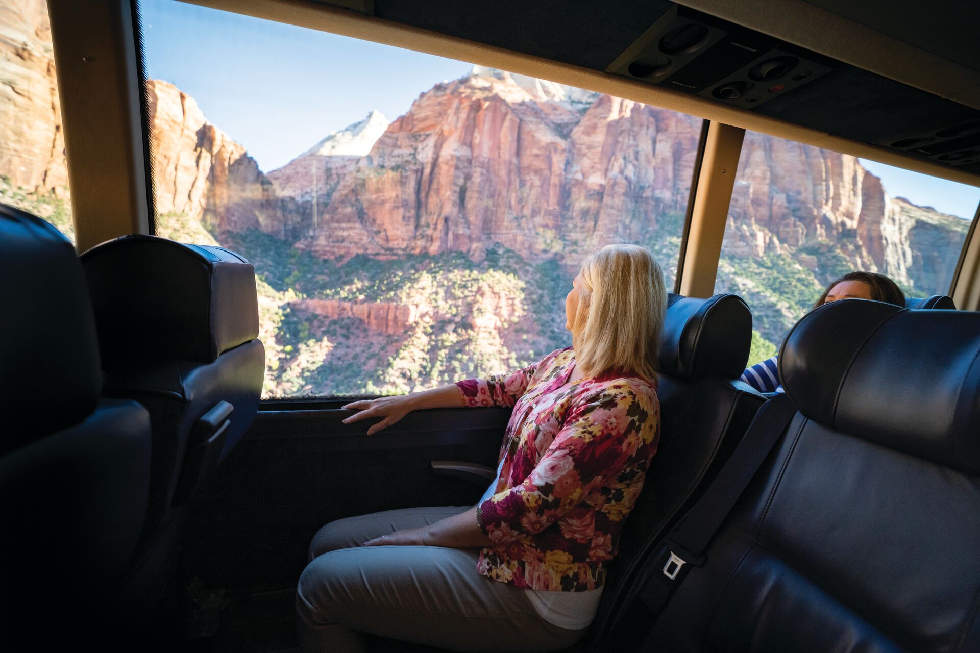 Guests looking out a Zion National Park in Utah, USA from an Insight Vacations bus
