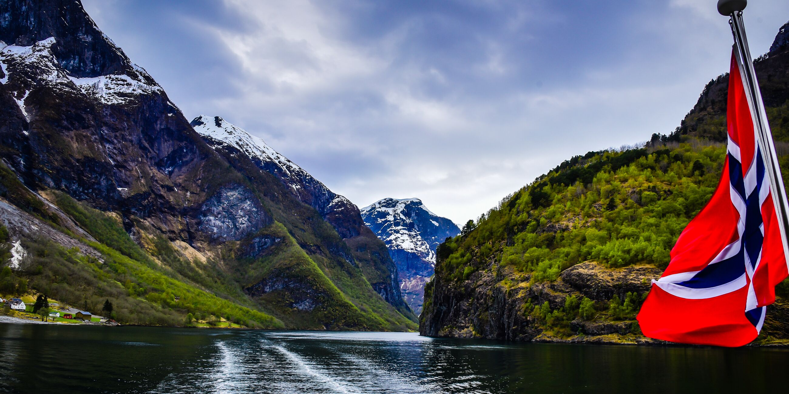 Cruise On The Nærøyfjorden in Norway with the Norwegian flag in the foreground