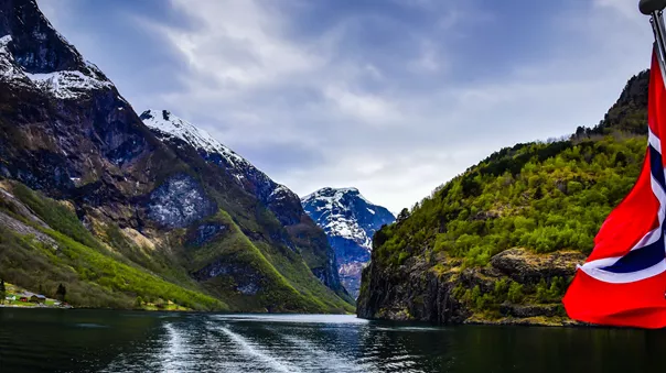Cruise On The Nærøyfjorden in Norway with the Norwegian flag in the foreground