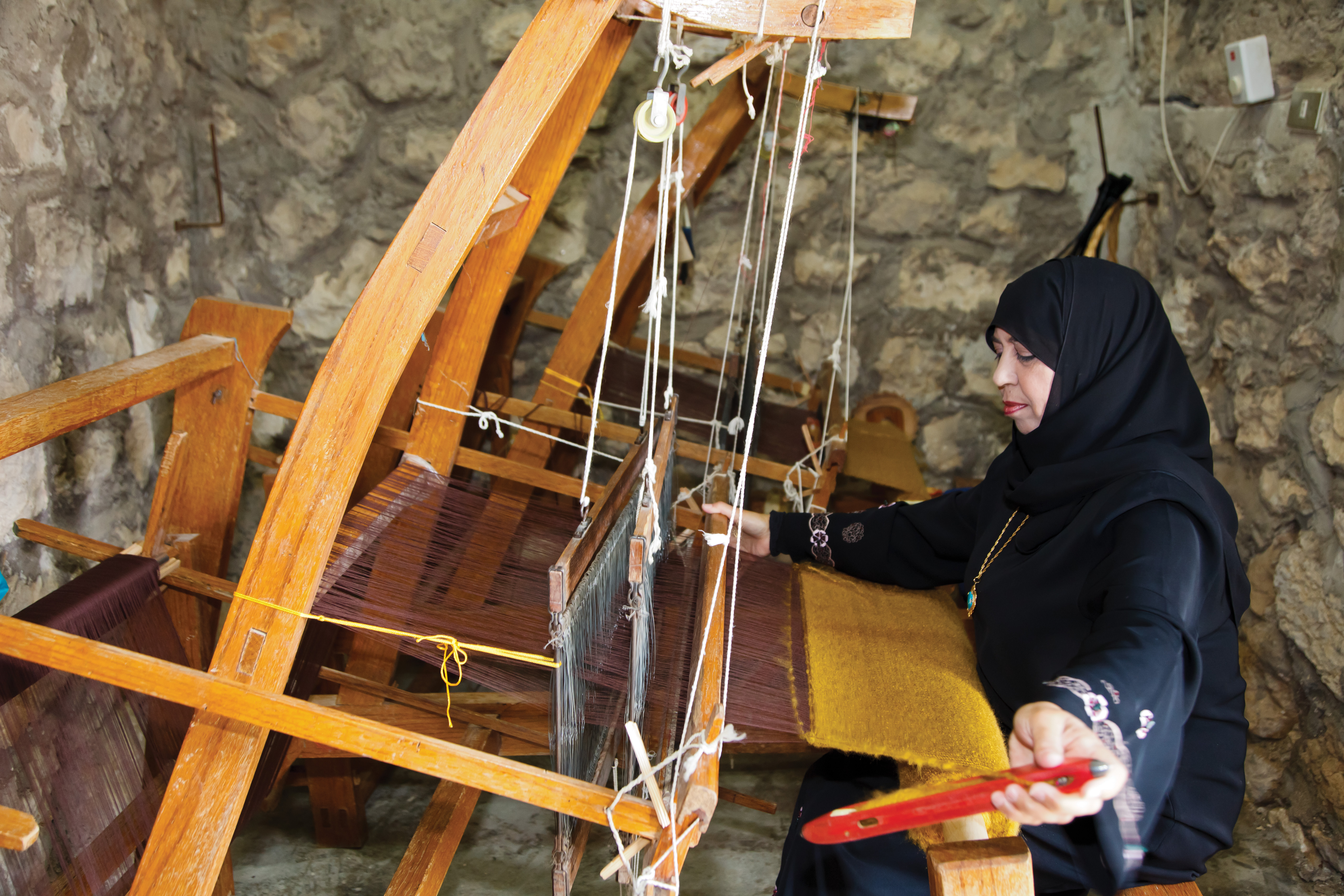 A woman in a headscraf is yarning