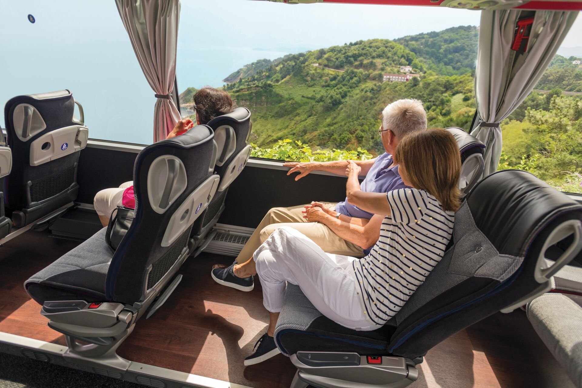 Couple looking through their coach window at San Sebastian in Spain