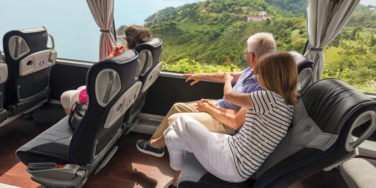 Couple looking through their coach window at San Sebastian in Spain