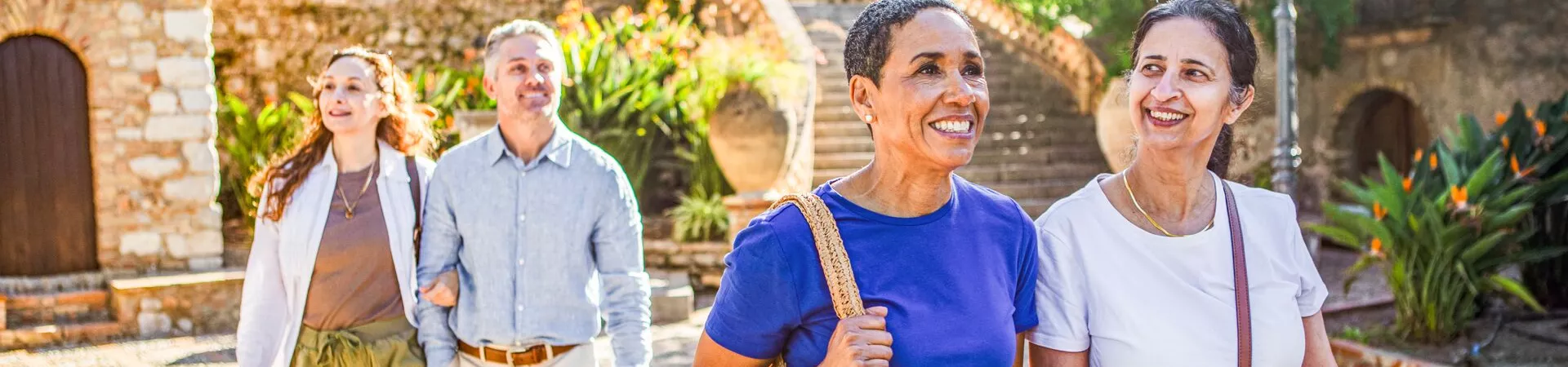 Guests walk through an historic courtyard in Taormina, Sicily