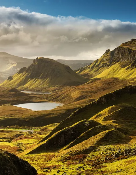 Large Scenic View Of Quiraing Mountains In Isle Of Skye, Scottish Highlands, United Kingdom Sunrise Time With Colourful An Rayini Clouds In Background 1218375340